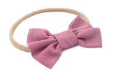 Pink nylon headband for newborn girl from By Bella Boutique.